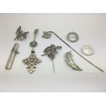 A small collection of silver and white metal brooches and other items.