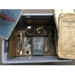 A box containing a collection of oddments including a cased set of weighing scales, maps, etc