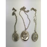 Three silver lockets on chains, various hallmarks.