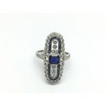 An elongated platinum, sapphire and diamond ring.