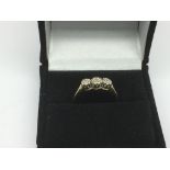 A 9ct gold three stone diamond ring, approx 1.5g a