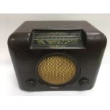 A Bush bakelite radio, missing back cover.