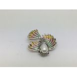 A silver flying fish brooch set with opals, a hang