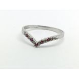 A 9ct gold wishbone ring set with rubies and diamo