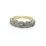 An 18ct gold diamond twist ring, approx .25ct, app
