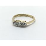 A 14ct gold and platinum three stone diamond ring,