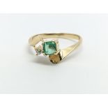 An unmarked gold ring set with a square emerald an