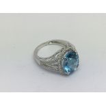 An 18ct white gold oval cut blue topaz and diamond