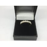 A ladies 18ct gold seven stone diamond ring, diamo