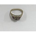 A 9 ct gold ring inset with garnets size L , 3 gra