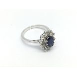 An 18ct white gold oval cut deep blue sapphire and