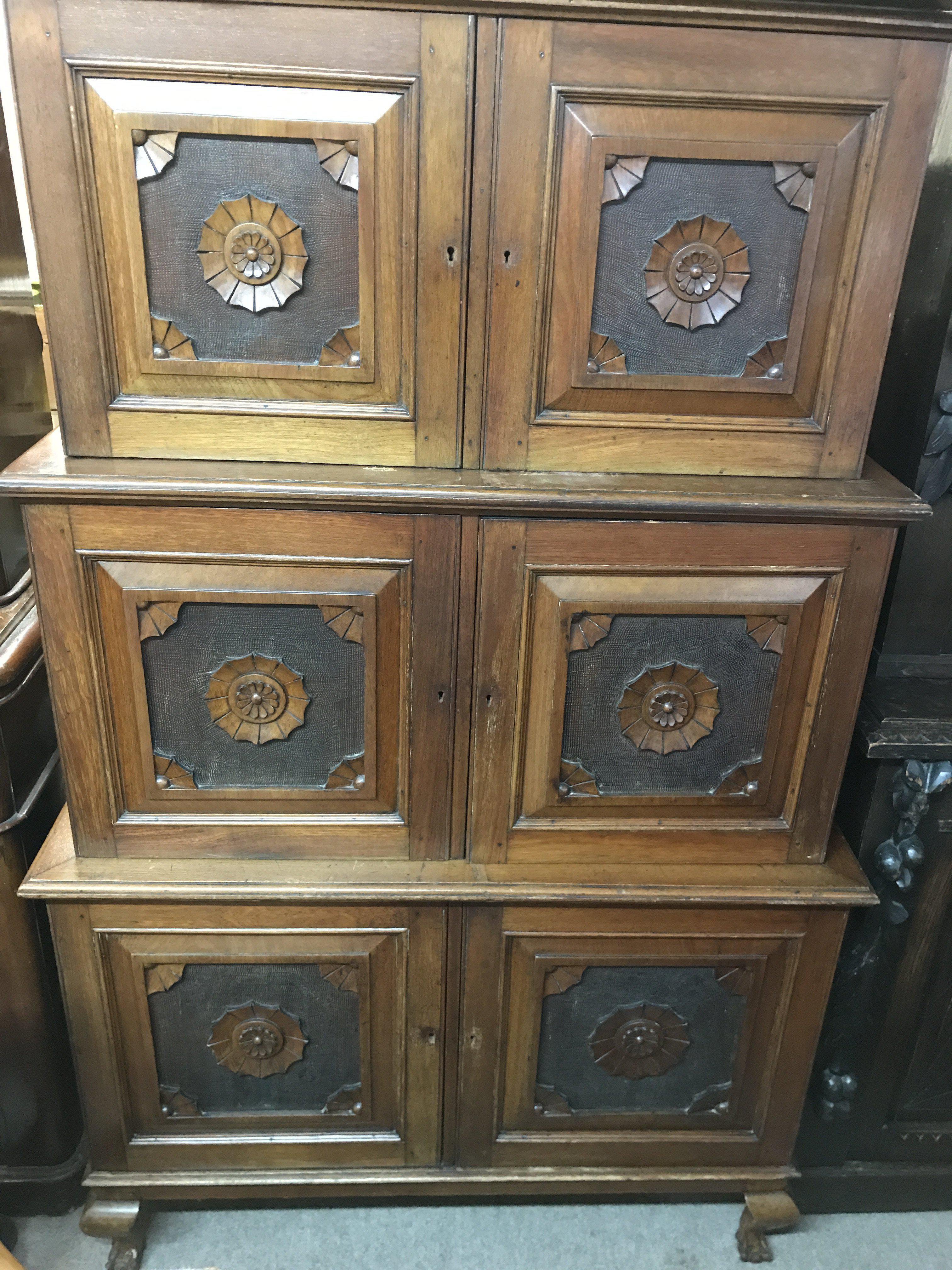 A Victorian walnut three sectional cupboard with Aesthetic influence on cabriole legs and ball and