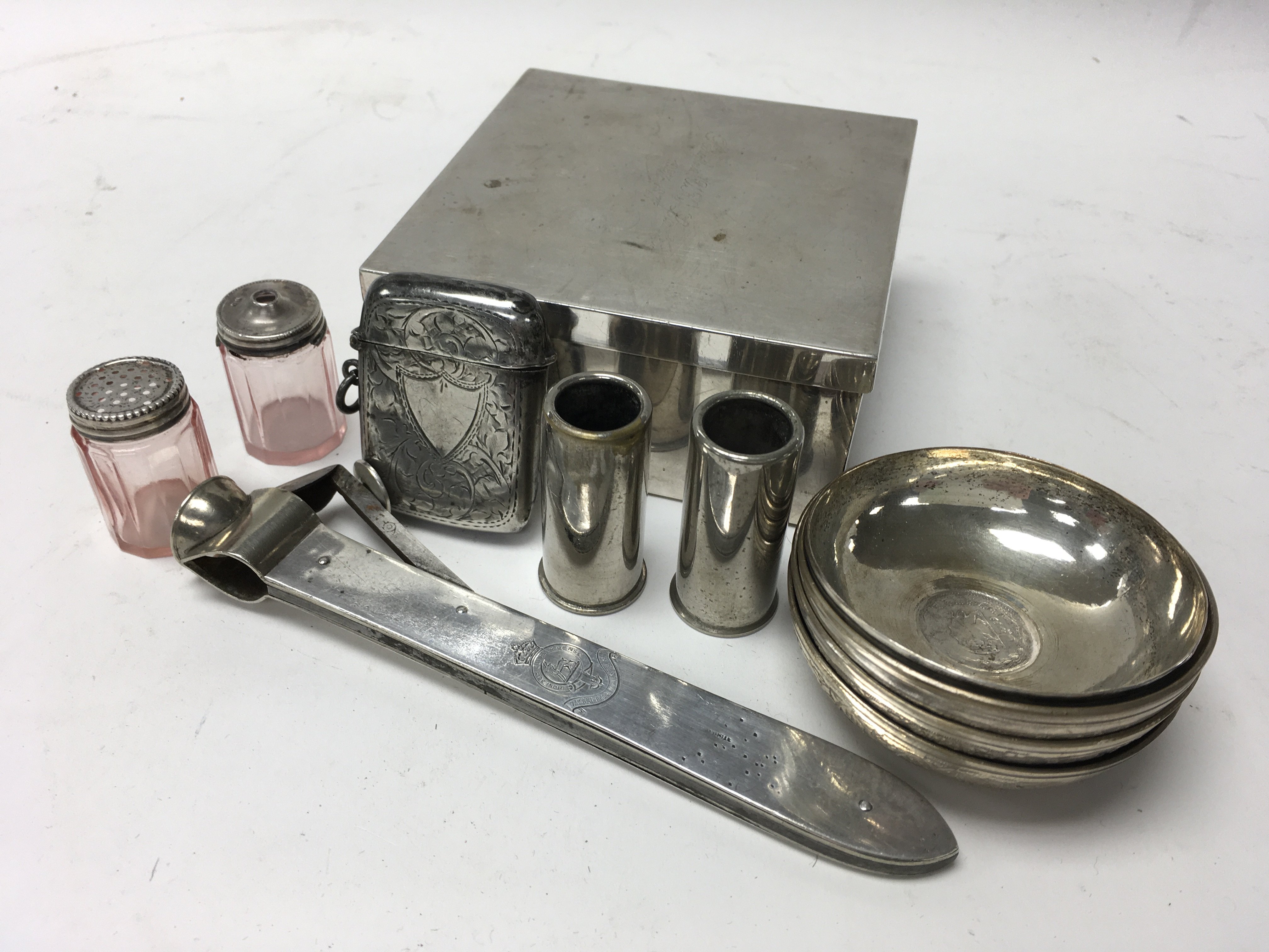 A bag of silver and white metal items inc a silver mounted cigar cutter with military crest.