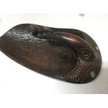 A Maori carved hard wood hand paddle scoop inset with mother of pearl (slightly split) length 35cm