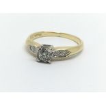 An 18ct gold solitaire diamond ring with further d