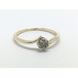 A 9ct gold diamond ring in the form of a flowerhea