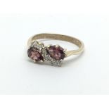 A 9ct gold ring set with two armadine garnets and
