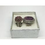Two silver and ruby rings.