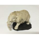 A carved ivory figure in the form of an elephant Hight 7cm