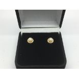 A pair of 9ct gold pearl stud earrings.
