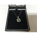 A modern design white gold necklace and pendent set with an Emerald in a geometric Mount set with