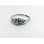 A fine 9ct gold ring set with a central topaz and