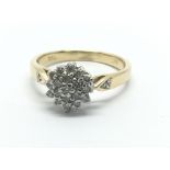 An 18ct gold diamond cluster ring in the form of a flowerhead, approx 3.4g and approx size L.