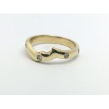 An unusual gold eternity ring set with eight diamo