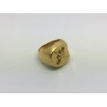 An unmarked gold ring decorated with an unusual em
