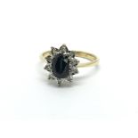 An 18ct gold ring set with a central sapphire and