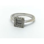 An 18ct white gold eing set with three emerald cut