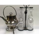 A silver plated tantalus inset with two cut glass decanters with enamel gin and sherry labels .and a