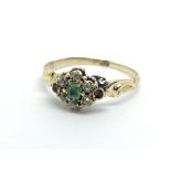 An unmarked gold emerald and diamond ring (stones