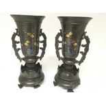 A pair of Japanese bronze vases of the Meiji period inlaid with gold flowers and with raised rabbits