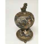 A Japanese late 19th century satsuma Koro Profusely decorated with figures and a raised dragon.