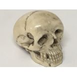 A 19th century ivory carving in the form of a skull height 4cm