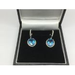 A boxed pair of 18ct white gold oval cut blue topa