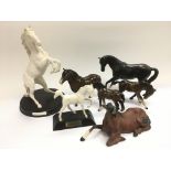 A collection of Royal Doulton and Beswick figures of horses.