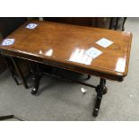 A Victorian walnut occasional table with a rectangular top on turned supports.