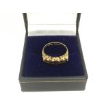 A 9ct gold ring set with five garnets, approx 2.1g and approx size L-M.