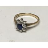 A 9carat gold ring set with a sapphire and small brilliant cut diamonds ring size N-O