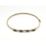 A 9ct gold sapphire and diamond bangle, approx 4.9g.