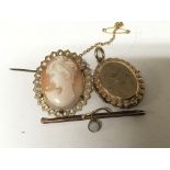 A 9carat gold mounted cameo brooch a gold locket and a brooch set with an opal (3)