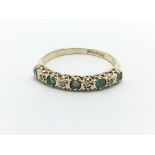 A 9ct gold half eternity ring set with alternating emeralds and diamonds, approx 1.3g and approx