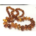 An irregular shaped amber necklace with graduating