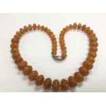 A graduating amber bead necklace, approx 100g.