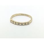 An 18ct gold seven stone half eternity diamond ring, approx .15ct, approx 1.8g and approx size N-O.