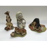 A Lladro figure of a child inuit plus three Border Fine Arts figures of animals (4).