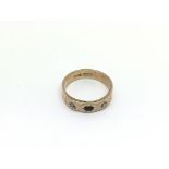 A 10ct gold ring set with small diamonds, one miss