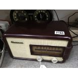 A vintage Champion burgundy Bakelite radio model 835.